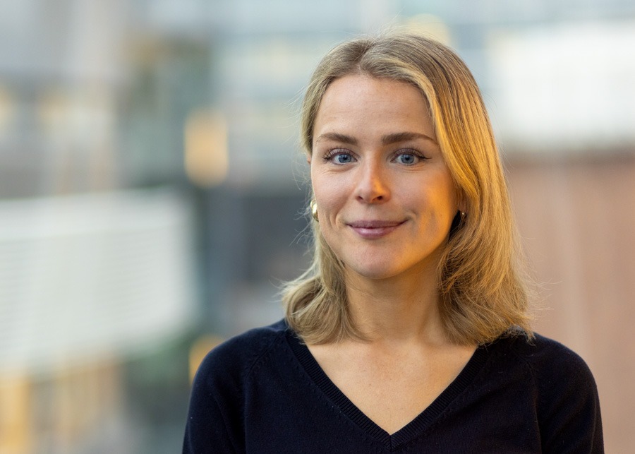 Karin Nedler in focus with blurry buildings in the background.