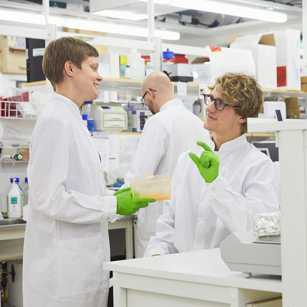 Scientists discuss in a lab environment