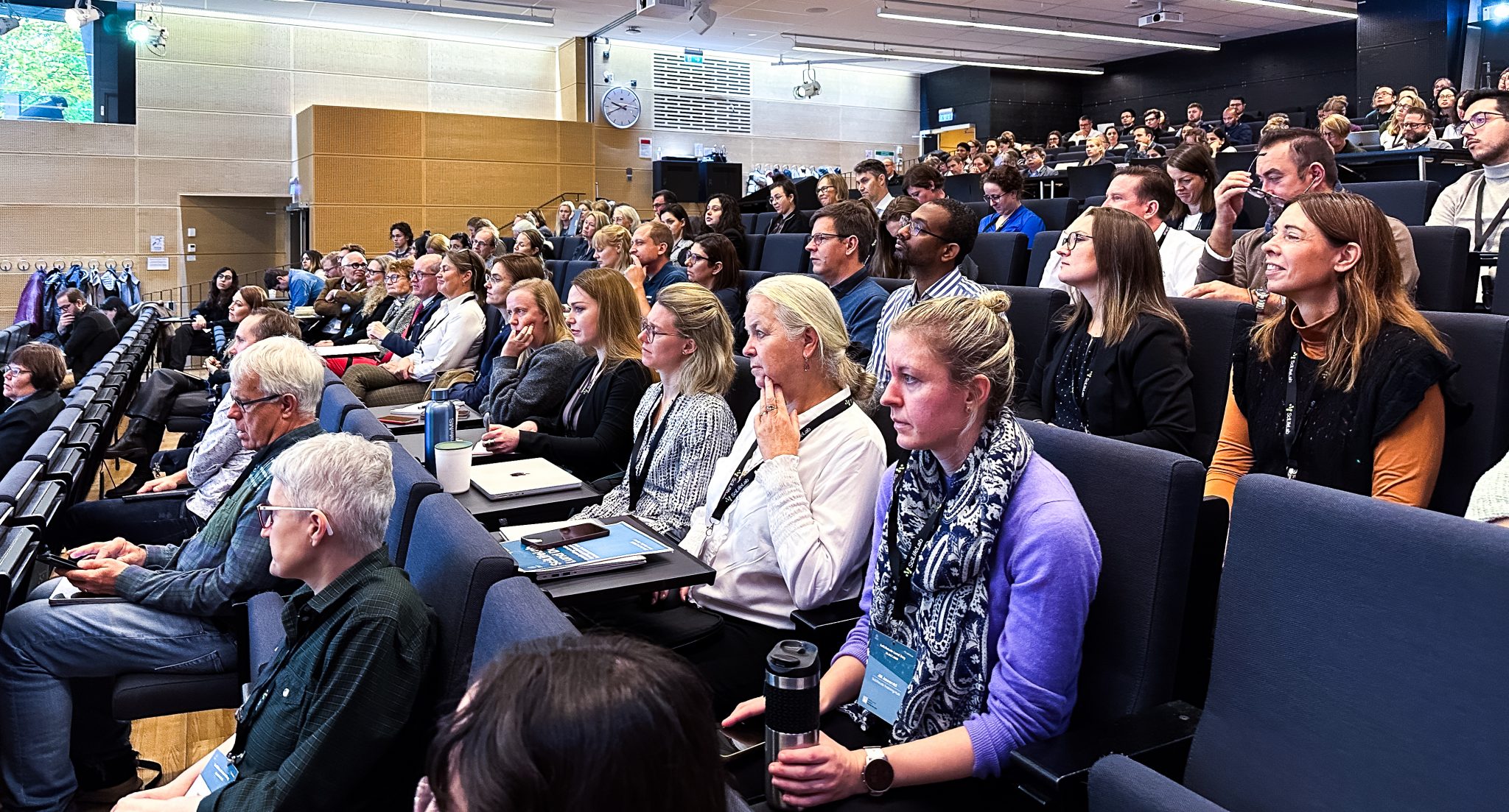 Lots of participants at SciLifeLab Lund day looking straight ahead, the person talking is not visible.